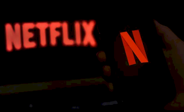 Netflix launches £4.99 package with adverts to lure cost-conscious streamers